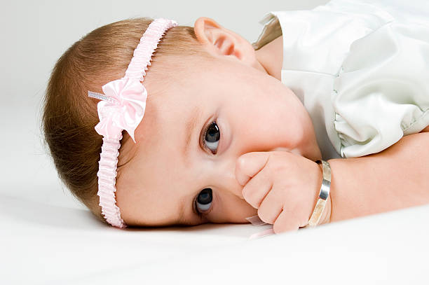 Cute Baby Laying Down  baby bracelet stock pictures, royalty-free photos & images