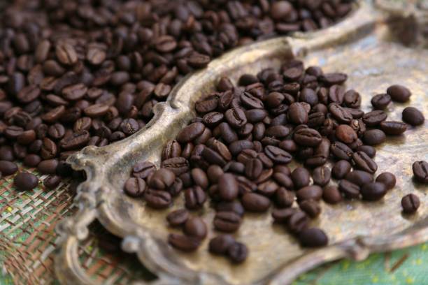 istock Coffee in grains is poured on the metal tray 1196188092