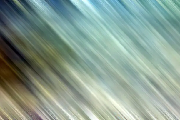Photo of Background pattern of motion blur with whiteish yellows, greens, browns and turquoises.