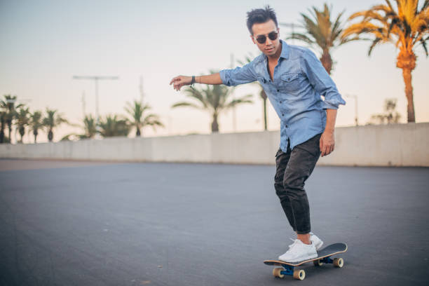 istock Hipster man riding skateboard 1196190596