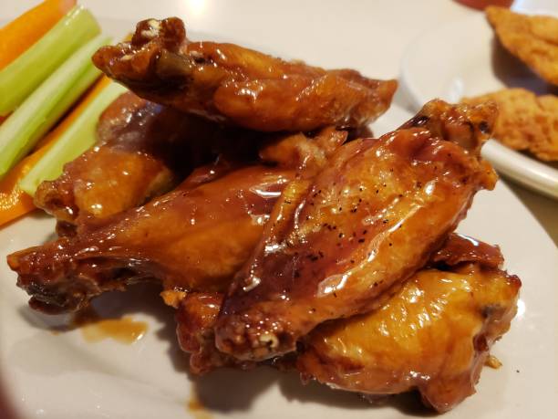istock Teriyaki Chicken Wings  with carrot and celery 1196190675