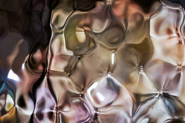 Cold colors bokeh blur abstract festive background reflections on the metal surface.