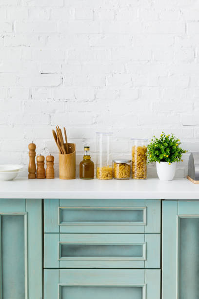istock modern white and turquoise kitchen interior with kitchenware, food containers and plant near brick wall 1196199335