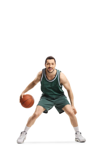 istock Basketball player in green jersey with ball 1196199955