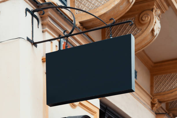 istock Blank Antique Black Store Signboard Mock up. Empty Shop Signage Template Mounted on Ancient Wall in European Town 1196204720
