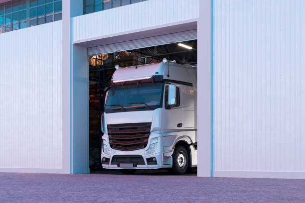 istock White Truck Leaving Garage With Bright Walls And Roller Shutter Door. 3d rendering. Empty Space 1196204993