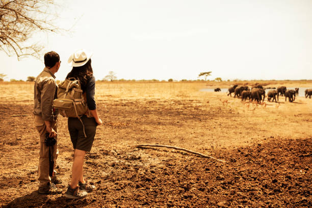 rear view  of two asian couple on grass when explore  wilderness area