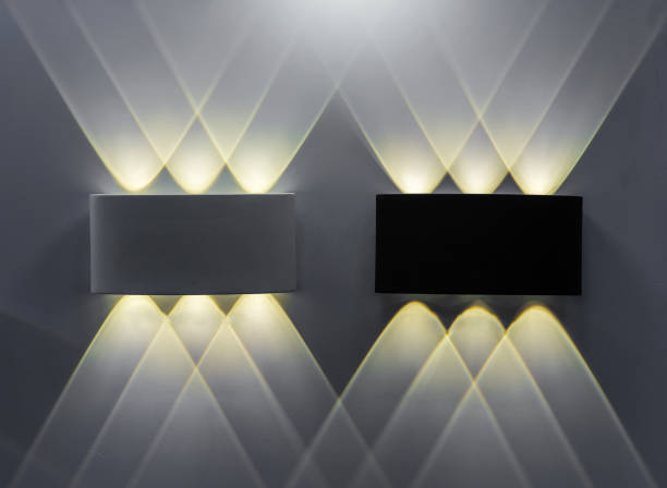 Two wall lights with symmetrical highlights on the wall.