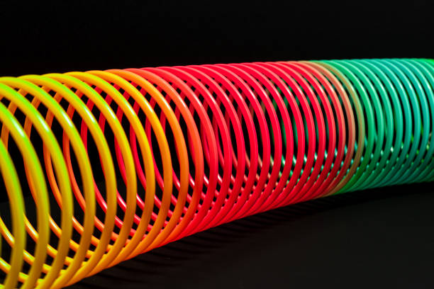 istock Close-Up Of Multi Colored Spring Against Black Background 1196208060