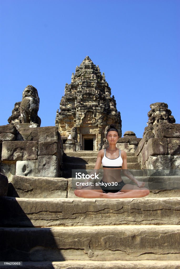 Virtual Woman in Yoga Easy Pose on a step of an old Angkor temple Virtual Woman in Yoga Easy Pose on a step of an old Angkor temple with a blue sky Adult Stock Photo