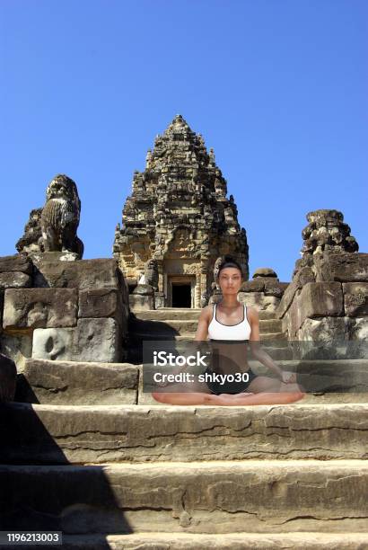 Virtual Woman In Yoga Easy Pose On A Step Of An Old Angkor Temple Stock Photo - Download Image Now