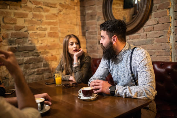 istock Hipster couple enjoying fun double date at local cafe 1196214017