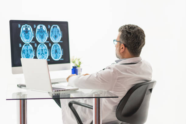 istock Males doctor examining brain MR 1196217404