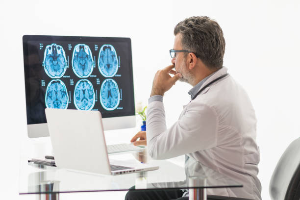 istock Males doctor examining brain MR 1196217723