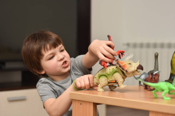 istock Child play with a dinosaur toys 1196221617