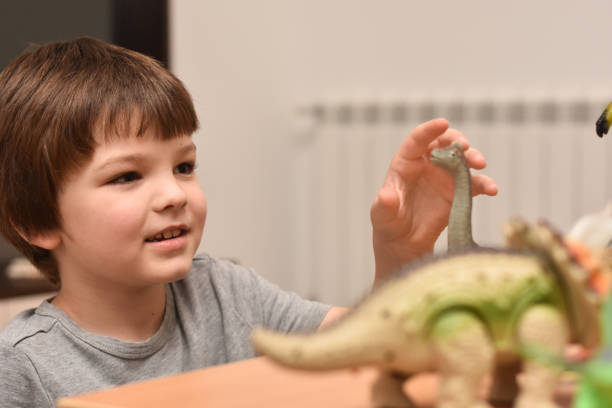 istock Child play with a dinosaur toys 1196221957