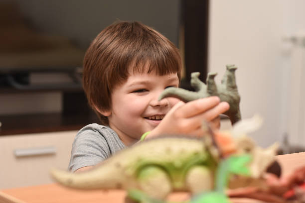 istock Child play with a dinosaur toys 1196222305