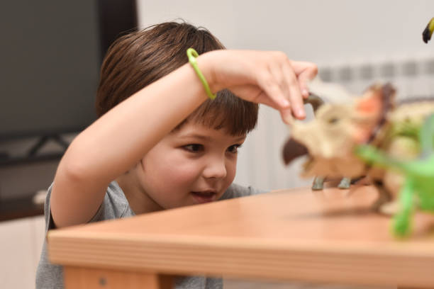 istock Child play with a dinosaur toys 1196222510