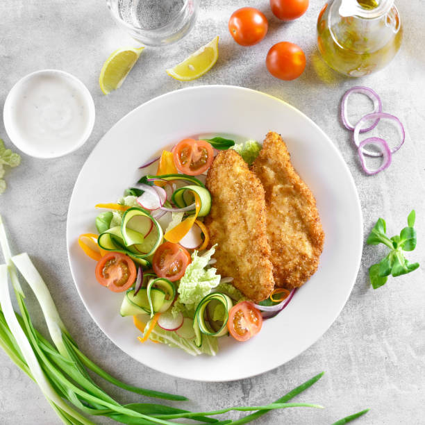 istock Fresh vegetable salad and breaded chicken breast 1196222522