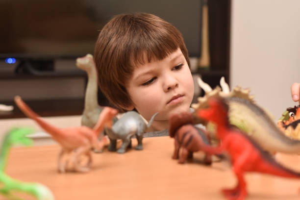 istock Child play with a dinosaur toys 1196224389