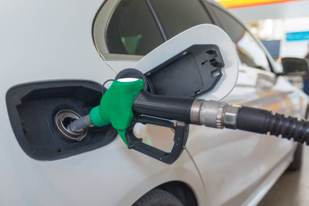 Green Fuel Drop From Gas Pump Nozzle Isolated on White. 3D Render