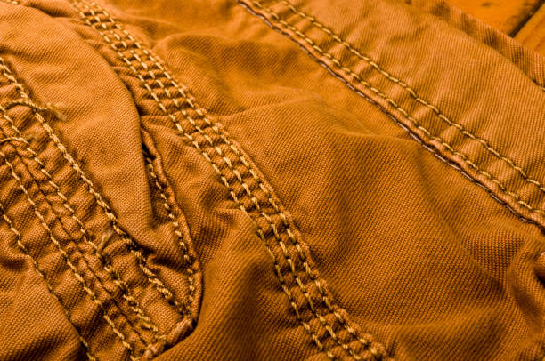 istock clothing items stonewashed cotton fabric texture with seams, clasps, buttons and rivets, macro 1196231646