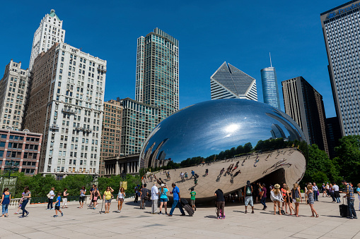 Chicago, Illinois, USA - July 1, 2014: People visiting the Cloud Gate sculpture, in the Millennium Park in the city of Chicago.