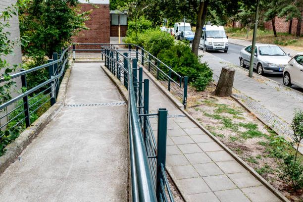 Wheelchair ramp residential building Berlin, Berlin/Germany - 11.07.2019: A long ramp for wheelchairs at a block of flats, which gives disabled tenants access to the building and makes it barrier-free. aids walk stock pictures, royalty-free photos & images