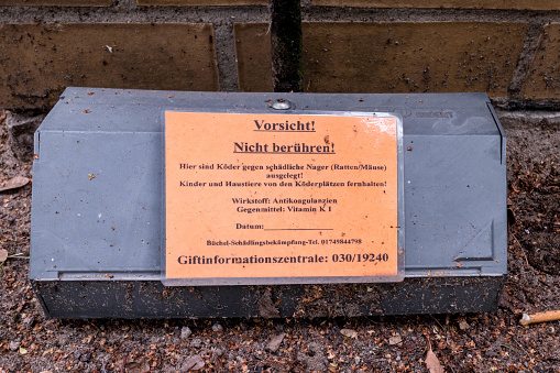 Berlin, Berlin/Germany - 16.07.2019: A rat trap incl. poison with a warning sign on it, which poison was used, which antidote and phone number of the poison center