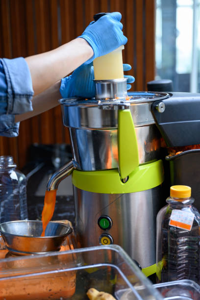 istock Making juice in electric juicer 1196235865