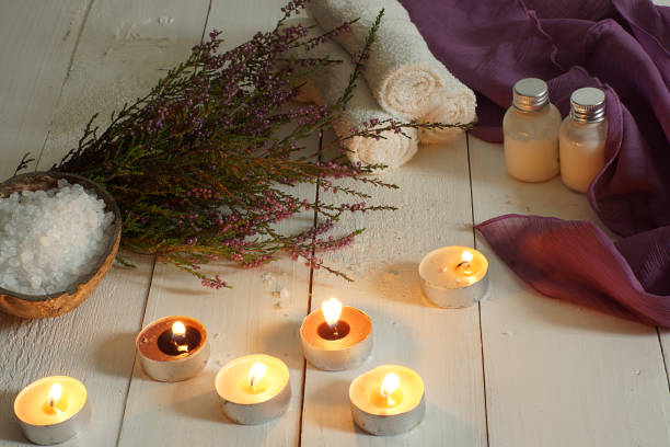 istock Burning candles and spa set with heather on a wooden table 1196242031