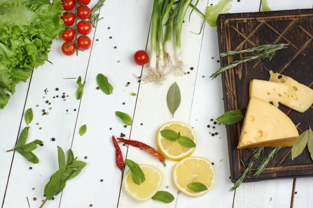 Bright fresh vegetarian food on white wooden table.