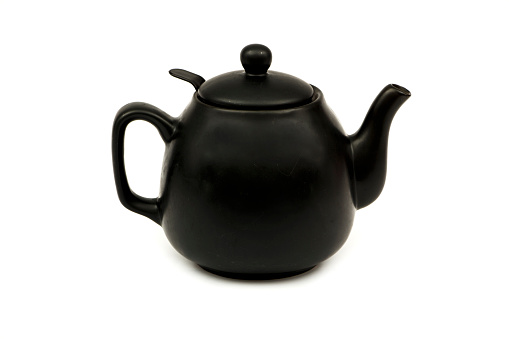 Black ceramic teapot for tea Isolated on a white background. Black teapot for tea on a white background.