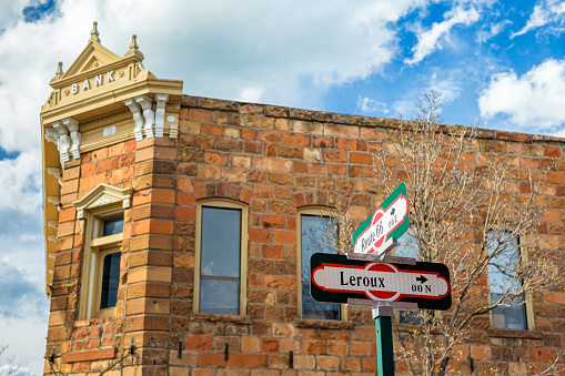 Cityscape view of historic Route 66 and Leroux street signs in Flagstaff, Arizona.