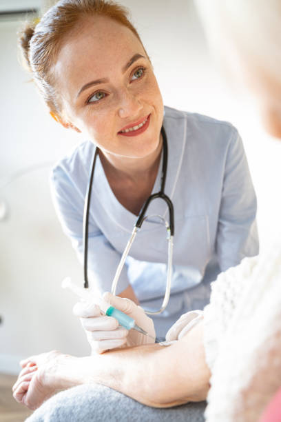 istock Pleased young practitioner treating her aged patient 1196243828