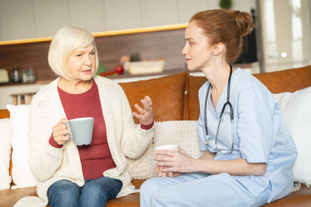 istock Two females having break for tea during conversation 1196243848