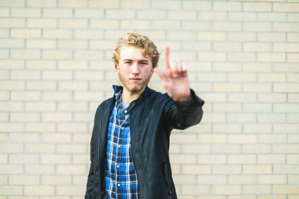 In Wetern Colorado Student holding up pointer finger indicating Number One Series (Shot with Canon 5DS 50.6mp photos professionally retouched - Lightroom / Photoshop - original size 5792 x 8688 downsampled as needed for clarity and select focus used for dramatic effect)