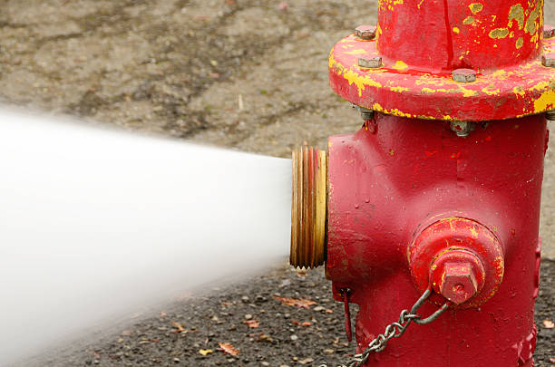 Open 5 inch  fire hydrant stock pictures, royalty-free photos & images