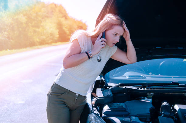 istock Woman Calling for car service help on the road 1196244849
