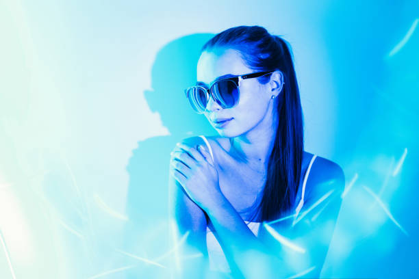 istock Night image of a woman in blue neon light flashes. 1196244898