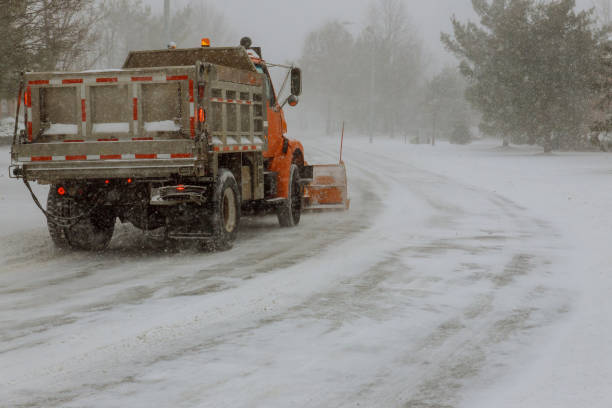istock The snow-removing car cleans the road on heavy snowfall. 1196245699
