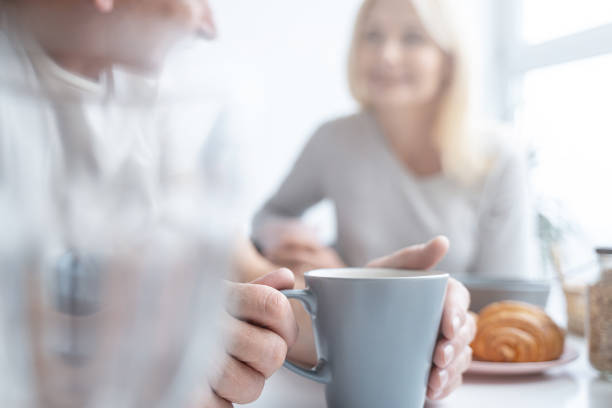 Blue mug in hands of person stock photo