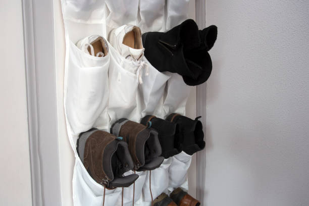 Shoe rack hanging on a wooden door, storage for shoes stock photo