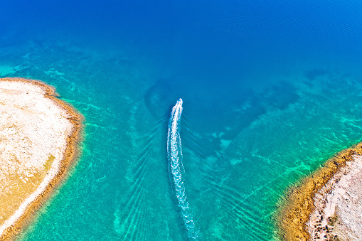 Archipelago of Croatia speed boat on turquoise sea, stone desert islands of Zadar, Dalmatia region of Croatia