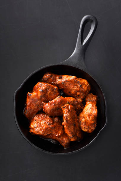 istock Chiken wings in a skillet 1196253271