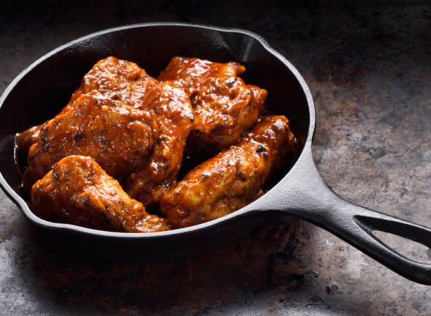 istock Chiken wings in a skillet 1196254497