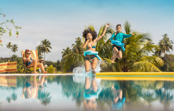 family bathing in luxury resort pool - hotel tourist resort luxury tropical climate imagens e fotografias de stock