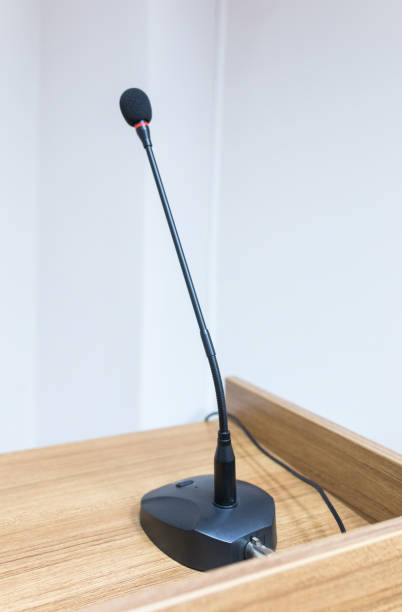 istock Speech Microphone on wooden speech stand and in conference room 1196256188