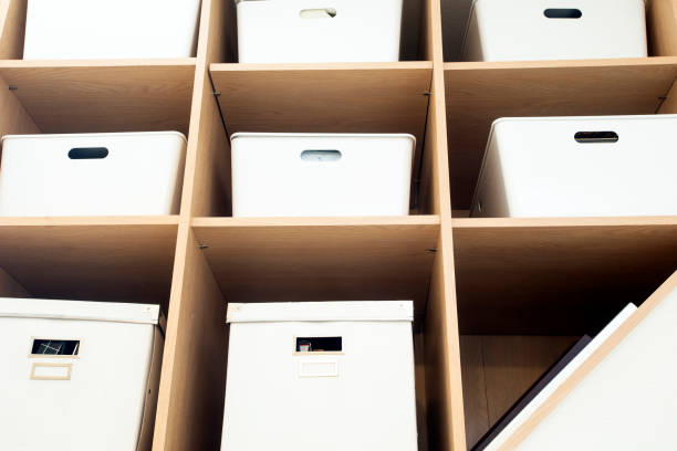 istock Modern interior white boxes in wooden shelfs for storage, modern interior clean up 1196257272