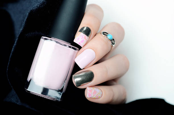 istock Delicate pastel pink manicure with broken glass design on black white background 1196257465